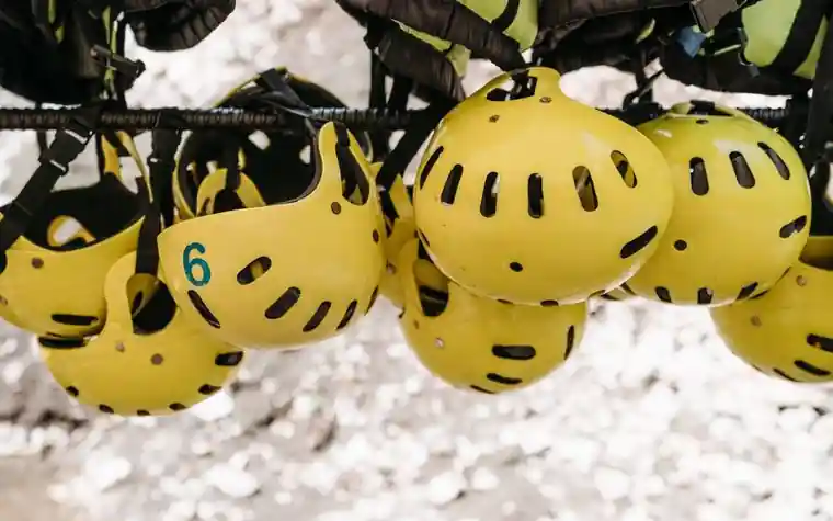 Yellow safety helmets hanging on a rack