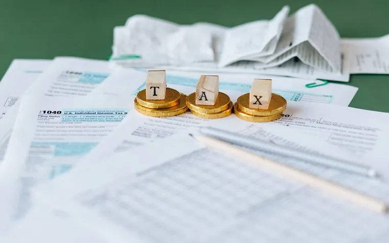 A desk with receipts, coins, and documents laid out