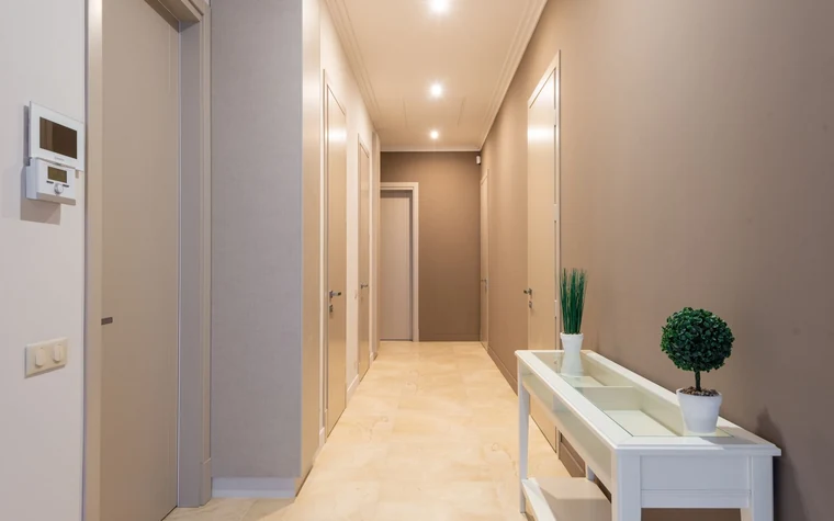 A lit interior corridor of an apartment building