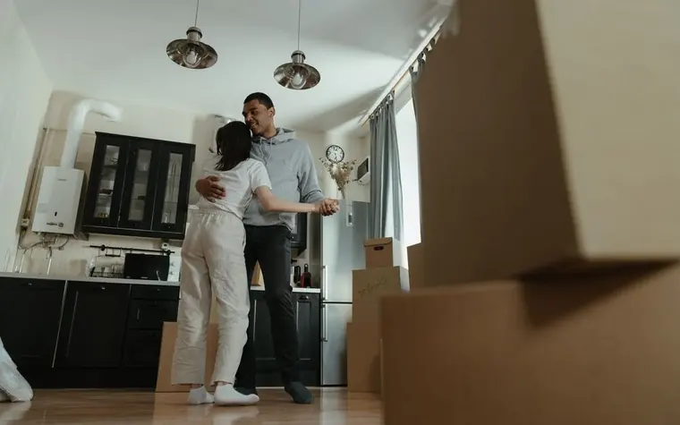 Checking documents amid moving boxes in an empty room
