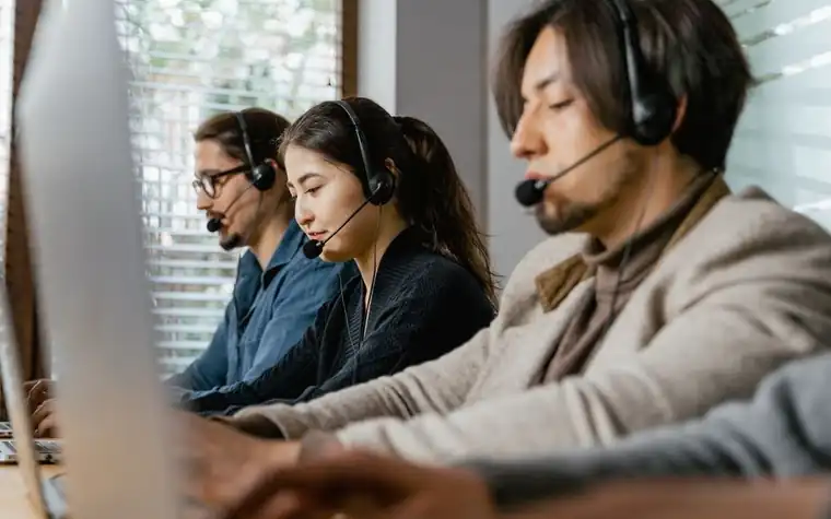 Call center agents wearing headsets handling customer calls
