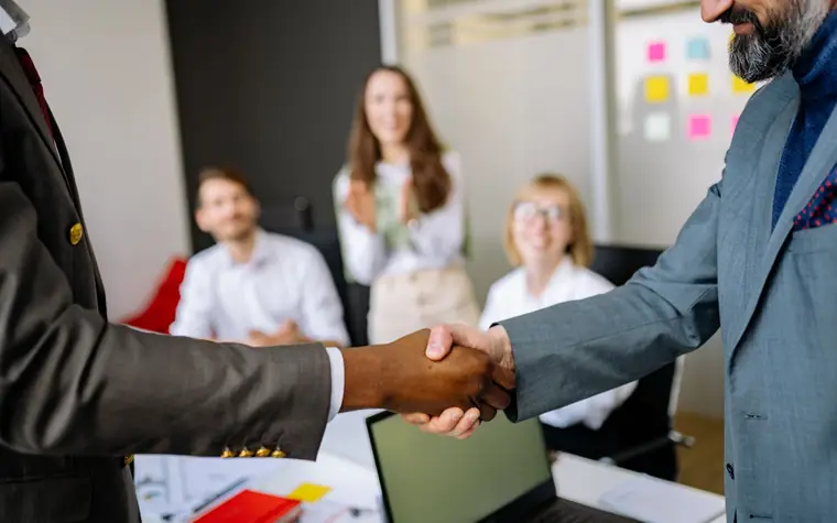 A handshake during a business meeting in an office