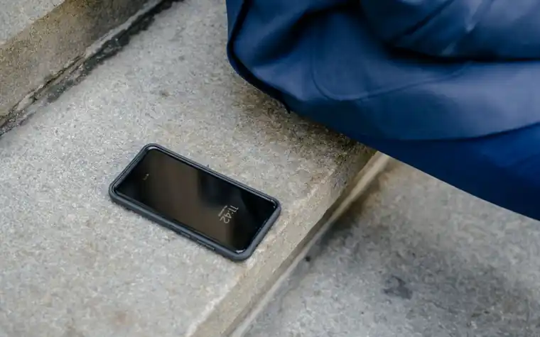 A smartphone left unattended on concrete steps