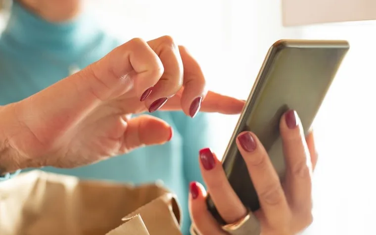 A finger tapping on a smartphone screen