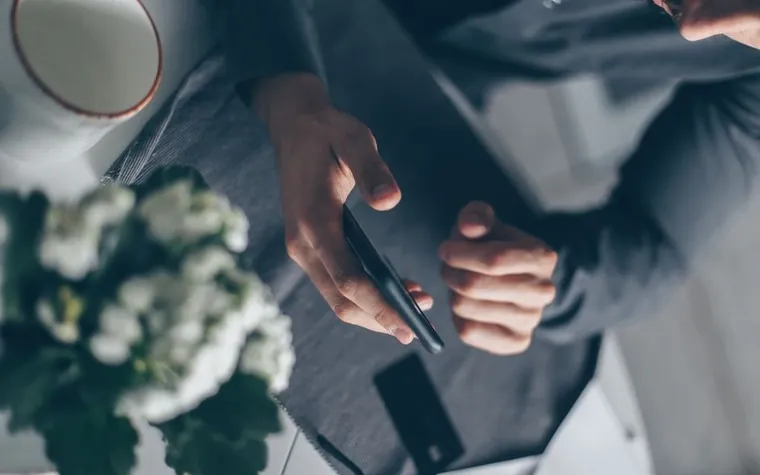 A hand checking a smartphone