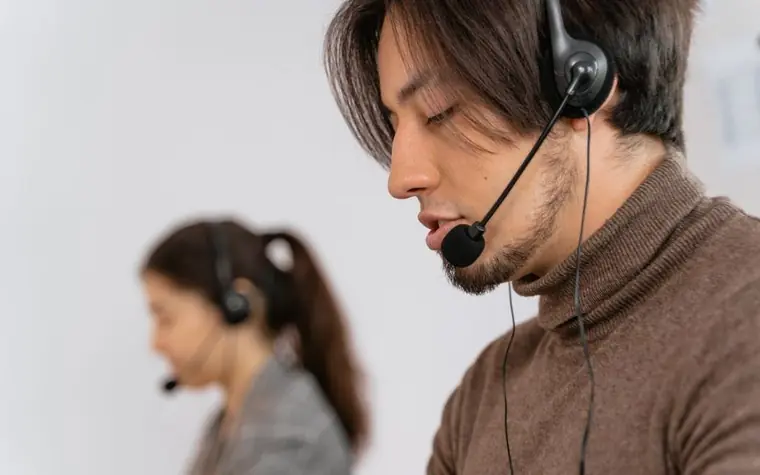 Call center agents wearing headsets assisting customers